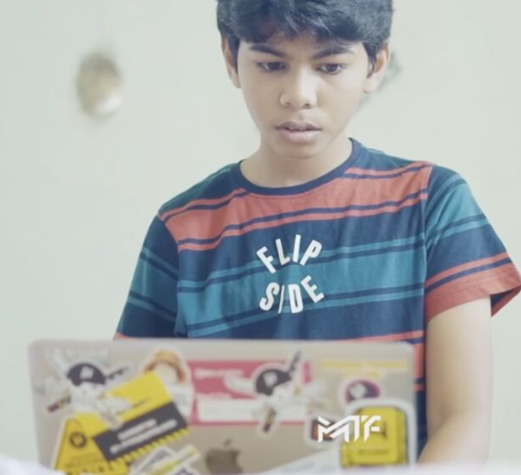 Riza Mohamed coding on laptop Kerala India