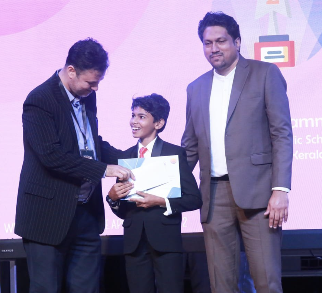 Riza Mohamed receiving certificate award on stage Kerala India